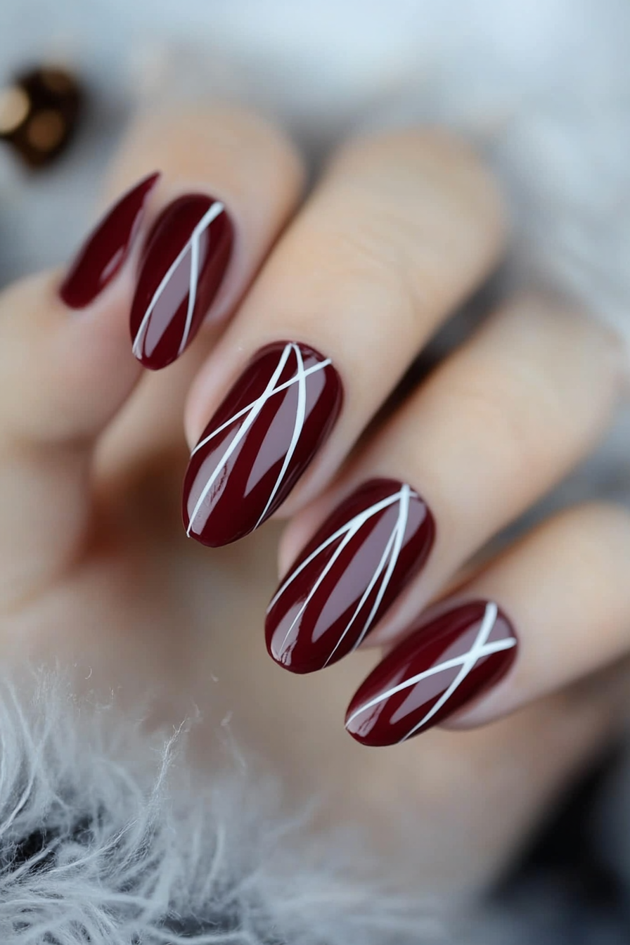 16. Glossy Maroon with Thin White Lines (Maroon Color Nail Design Ideas) - Maroon Color Nail Design Ideas
